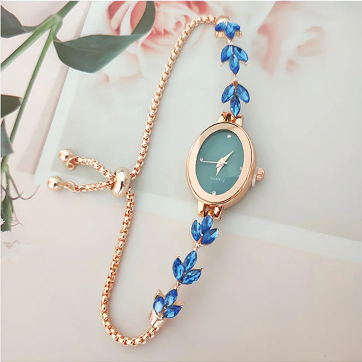 Elegant rose gold bracelet watch with blue leaf-shaped gemstones on adjustable chain