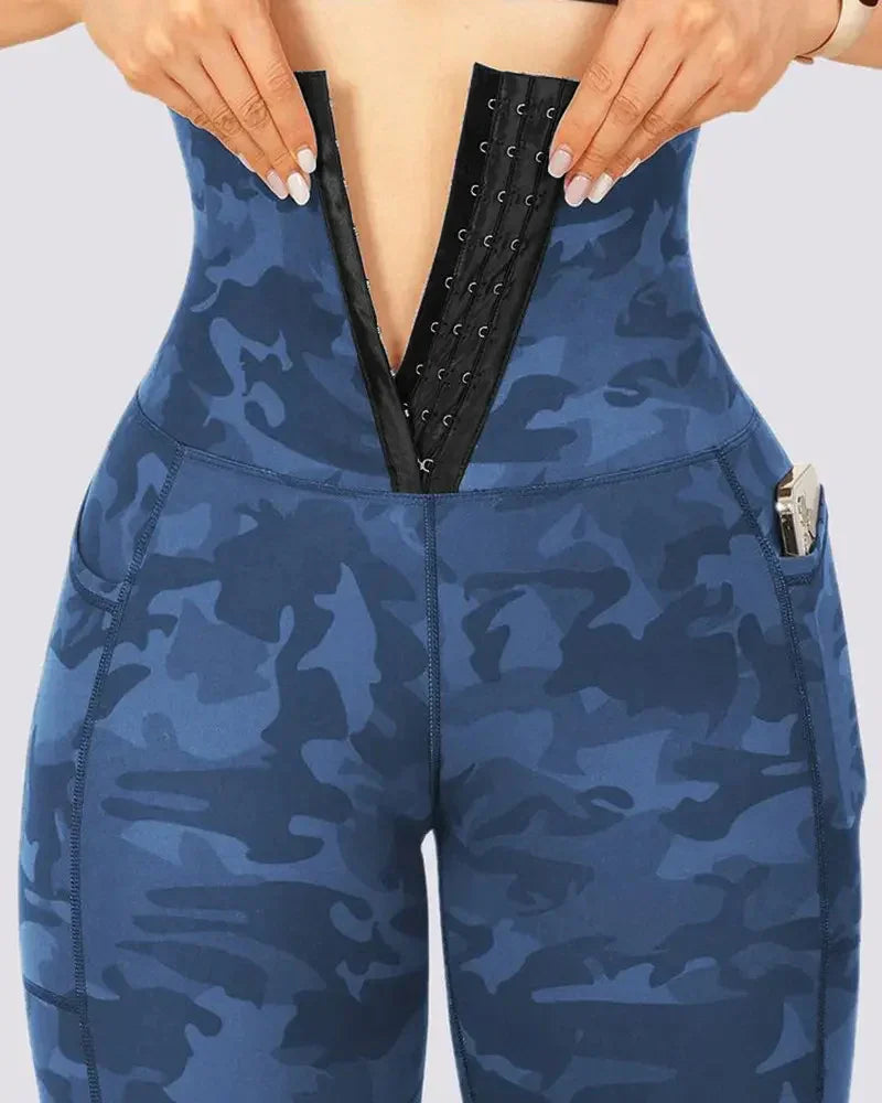 Woman wearing blue camo high-waist leggings with front hook-and-eye closure and side pocket