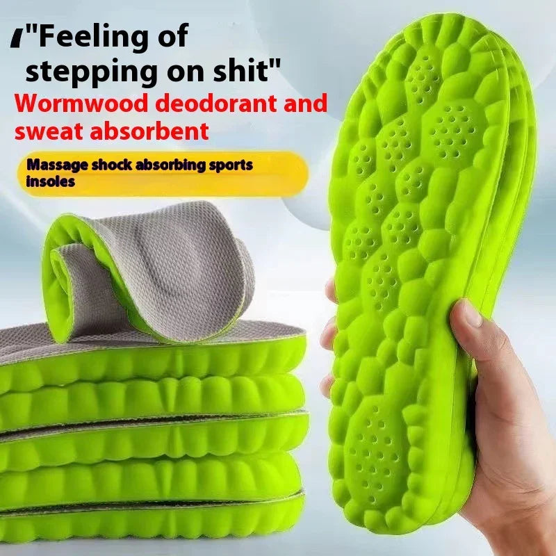 Hand holding bright green massage shock absorbing sports insole, stack of insoles with gray top layer