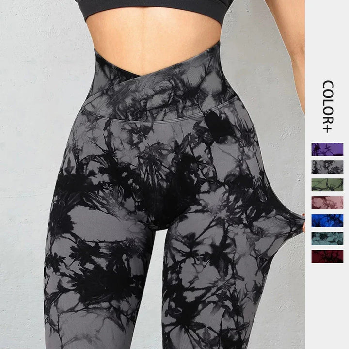 High-waisted black and gray tie-dye leggings with stretchy fabric detail, modeled on waist and hips