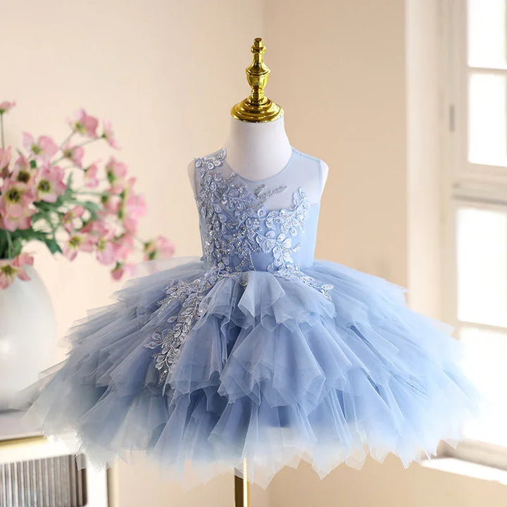 Blue sleeveless girl's party dress with layered tulle skirt and floral embroidery on mannequin