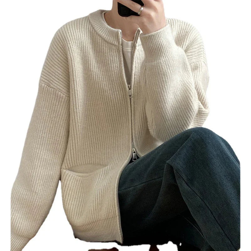 Person wearing cream ribbed zip-up cardigan and dark pants, casual cozy outfit