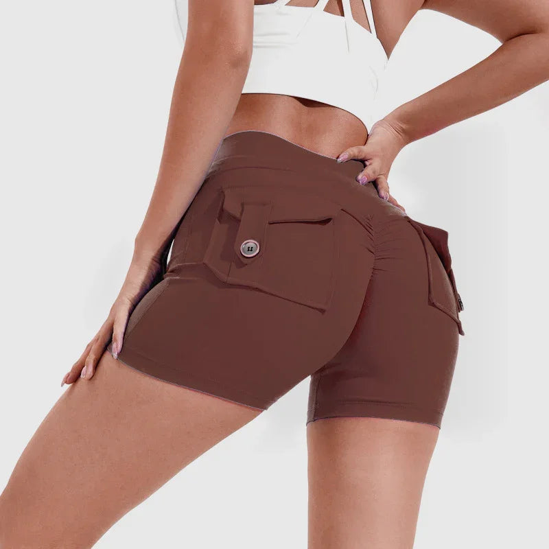 Close-up of woman wearing brown high-waisted cargo shorts with buttoned pockets and white crop top