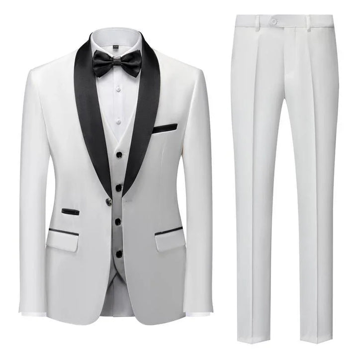 white men's tuxedo suit with black satin shawl lapel, black buttons, bow tie, vest, and white dress pants