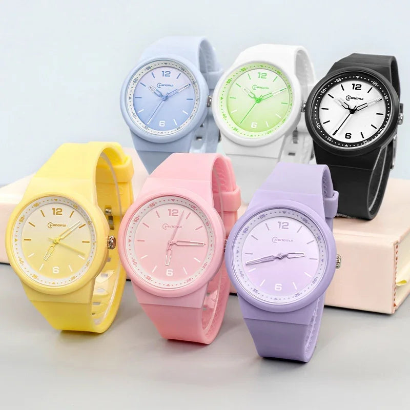 Colorful silicone wristwatches in yellow, pink, purple, pastel blue, white with green, and black with white faces