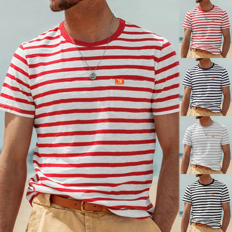 Man wearing casual striped t-shirts in red, navy blue, gray, and black with beige pants at the beach