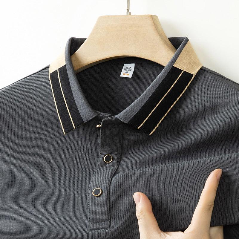 Close-up of dark gray polo shirt with beige and black striped collar on wooden hanger