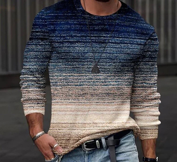 man wearing gradient knit sweater in blue, beige tones with jeans and black belt in urban setting