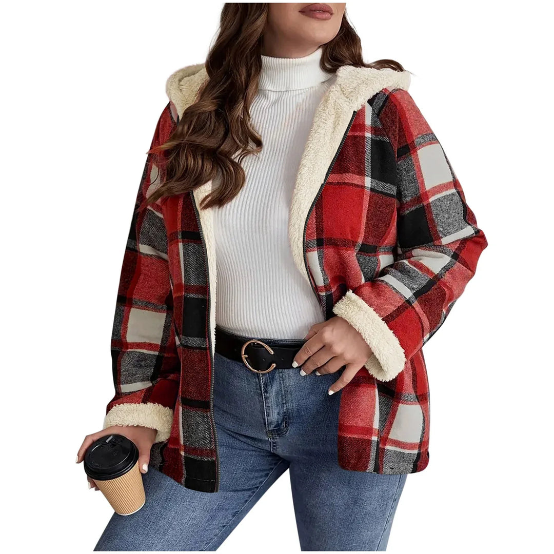 Woman wearing red plaid hooded sherpa jacket with white ribbed turtleneck and jeans holding coffee cup