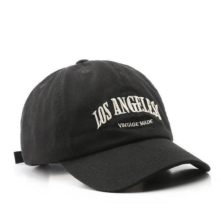 Black vintage-style baseball cap embroidered with Los Angeles text on front