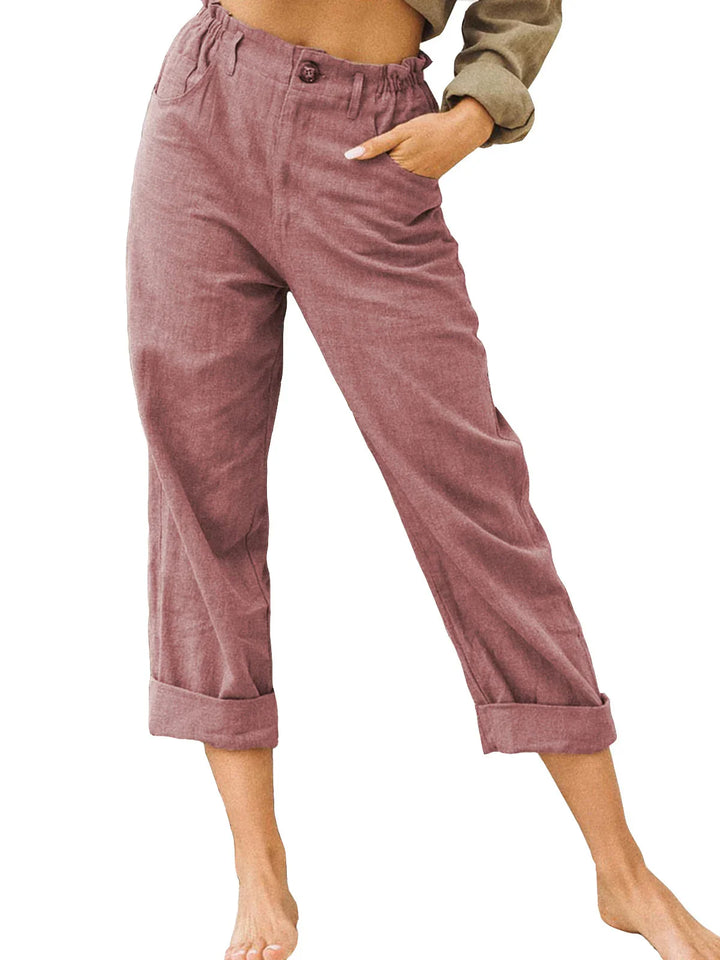 Woman wearing mauve casual cropped pants with cuffed hems and a high waist with button detail