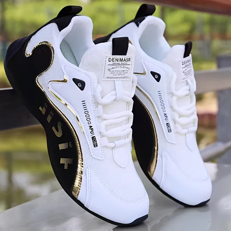 white and black DENIMASR sneakers with gold accents, stylish modern design, outdoors on reflective surface