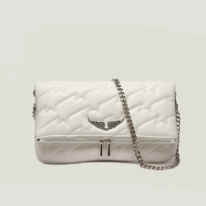 White quilted leather crossbody bag with star pattern and silver wing emblem, silver chain strap