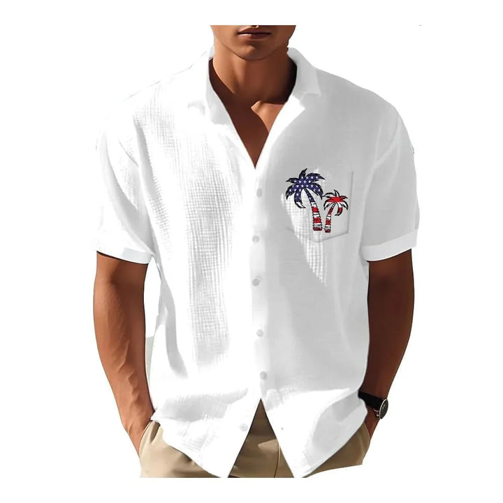 Man wearing white short-sleeve button-up shirt with American flag palm tree embroidery