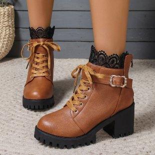 Brown leather lace-up ankle boots with block heels and buckle details worn with black lace socks