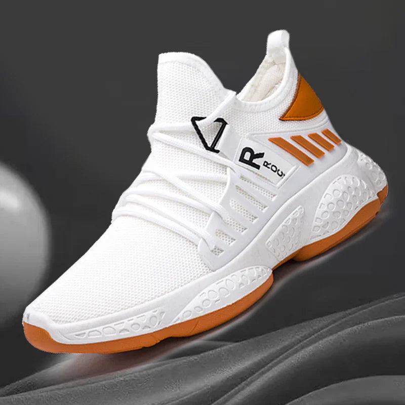 White and orange sport sneaker with mesh upper, elastic laces, and textured sole on gray background