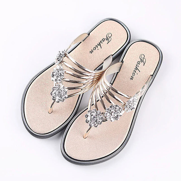 Elegant women's beige sandals with rhinestone flower decorations and black sole, top view