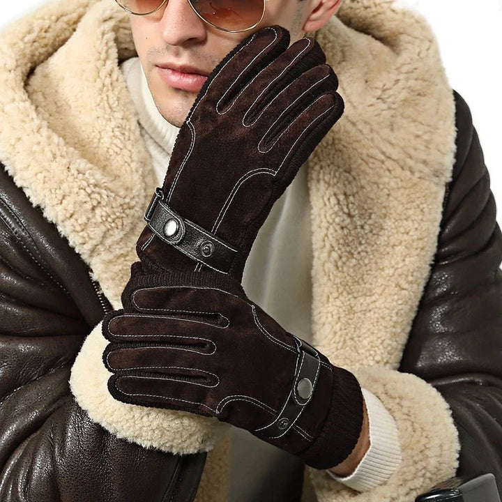 Man wearing brown suede winter gloves with black leather straps and shearling aviator jacket