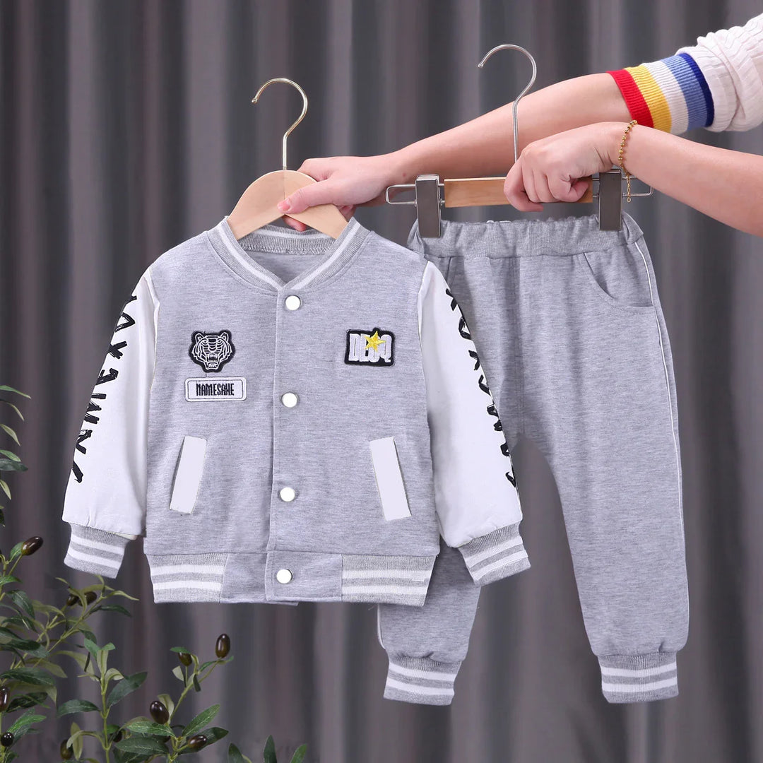 Gray and white kids varsity jacket and sweatpants set with tiger patch and striped cuffs