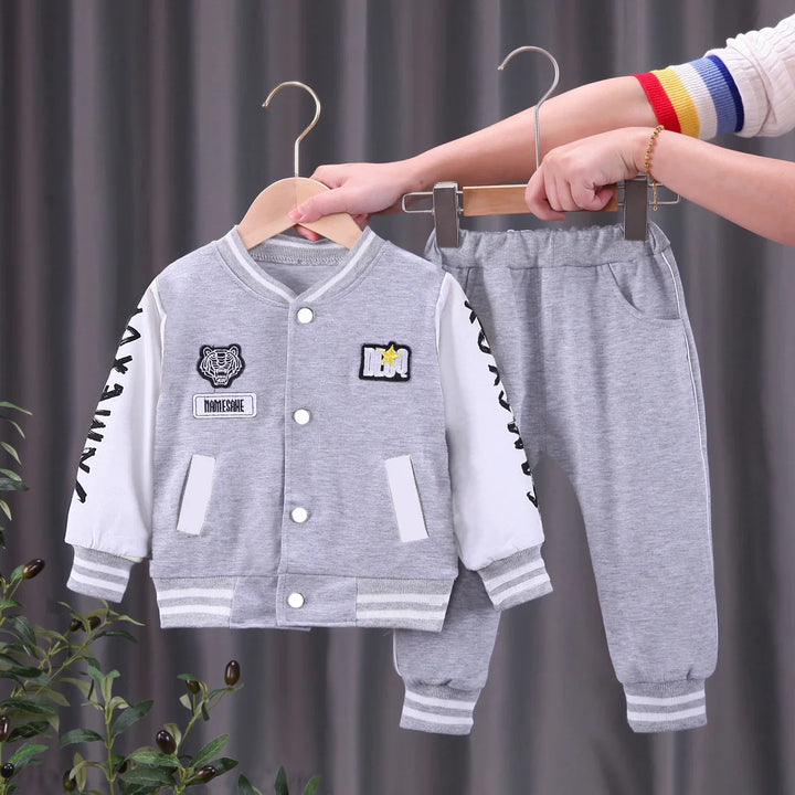 Gray and white kids varsity jacket and sweatpants set with tiger patch and striped cuffs