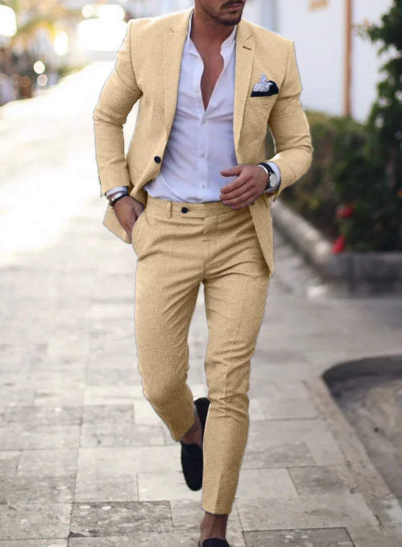 Man walking on street wearing beige slim-fit suit with white shirt and black loafers