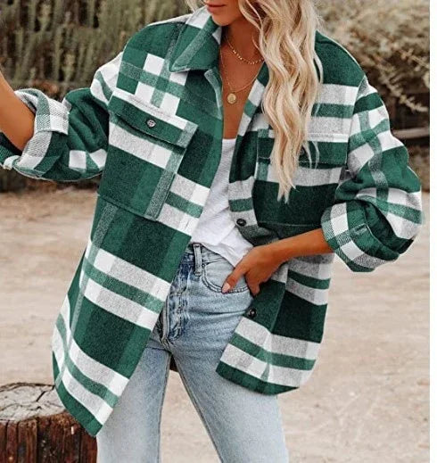 Woman wearing green and white plaid oversized jacket with chest pockets, paired with light blue jeans