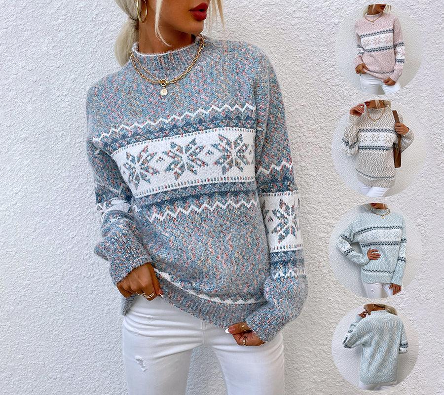 Woman wearing blue and white knit winter sweater with snowflake pattern and white pants