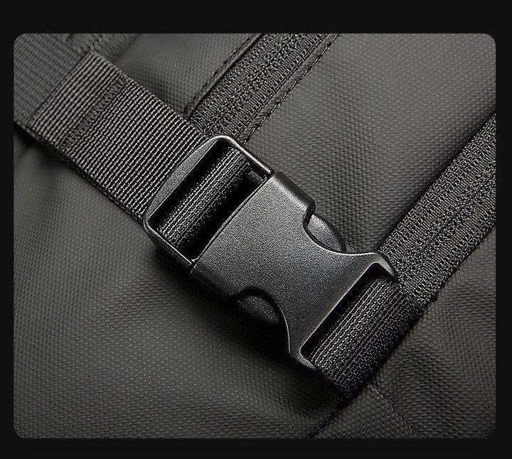 Close-up of black plastic buckle and strap on textured black fabric backpack