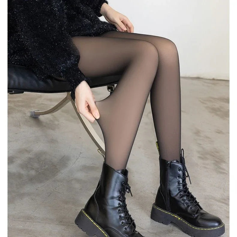 Close-up of woman wearing black sheer tights and black lace-up boots sitting on a chair