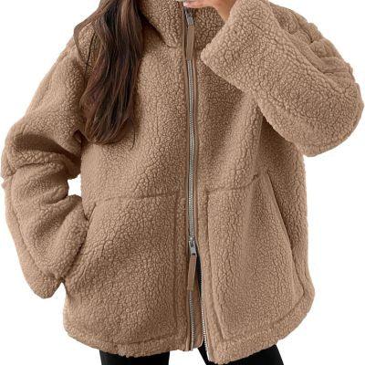 Close-up of person wearing cozy beige sherpa fleece jacket with front zipper and pockets