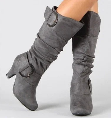 Grey suede mid-calf slouch boots with low heels and decorative buckle straps