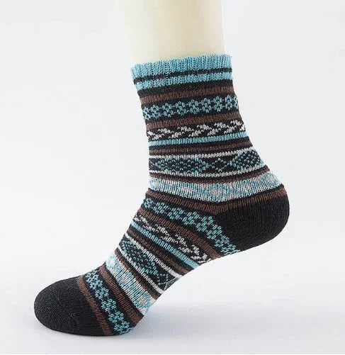 Striped wool sock with blue, brown, and black patterns on a white mannequin foot