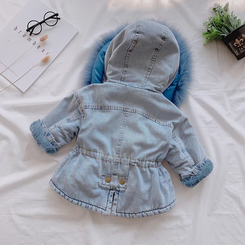 Light blue toddler denim jacket with hood and faux fur trim on cuffs and hood edge on white background