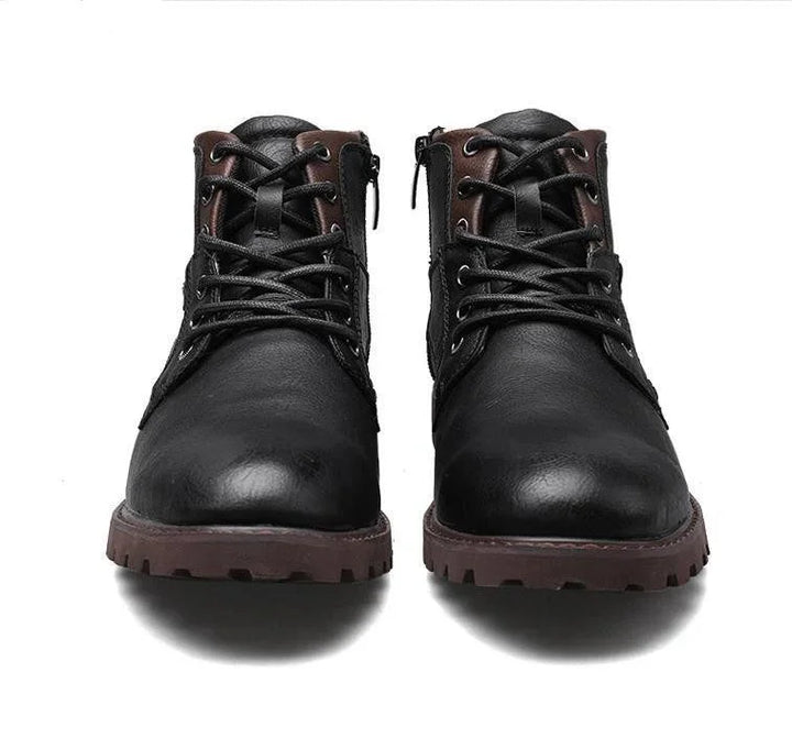 Black leather lace-up boots with brown padded collar and rugged brown soles shown from front