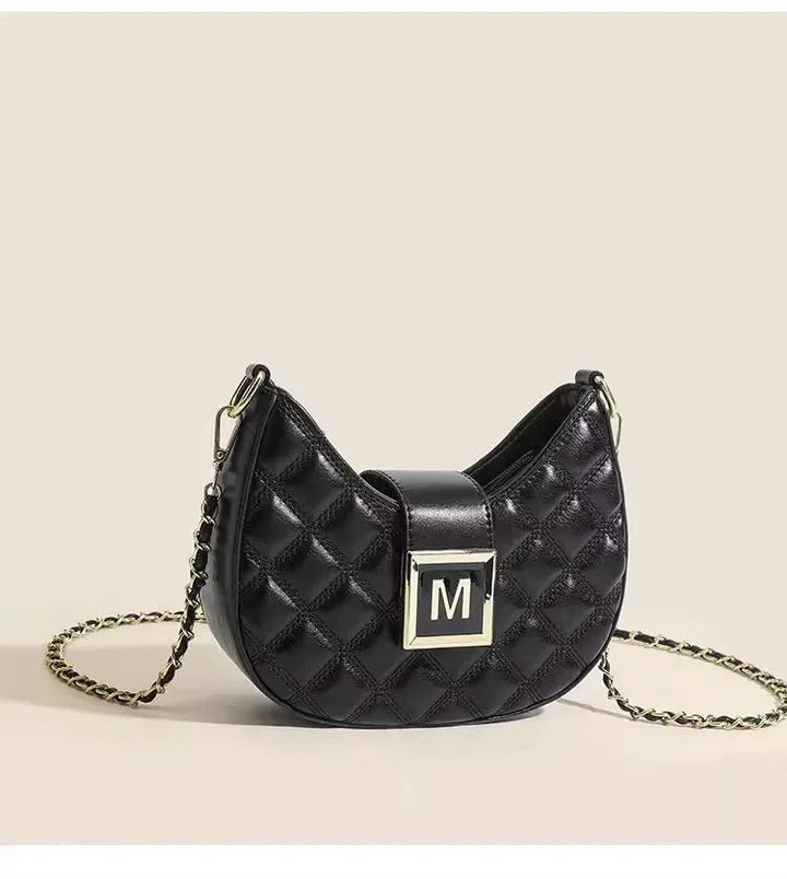 Black quilted leather crossbody bag with gold chain strap and square metal clasp with M logo