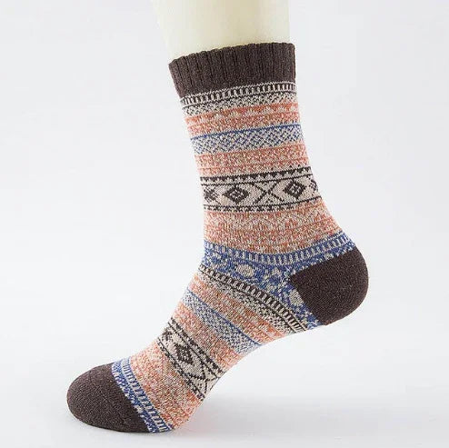 cozy patterned crew sock with brown, orange, blue, and black ethnic designs on white background