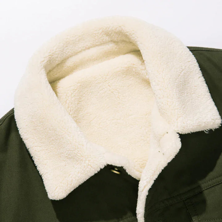 Close-up of green jacket with soft cream sherpa fleece collar and interior lining