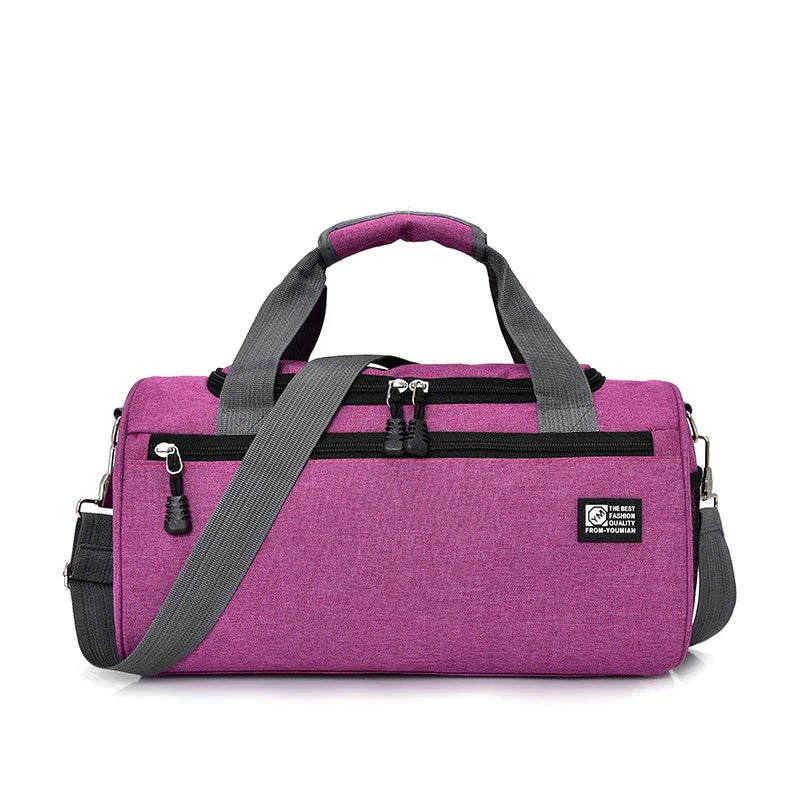 Purple cylindrical duffel bag with gray handles and adjustable shoulder strap, front zip pockets