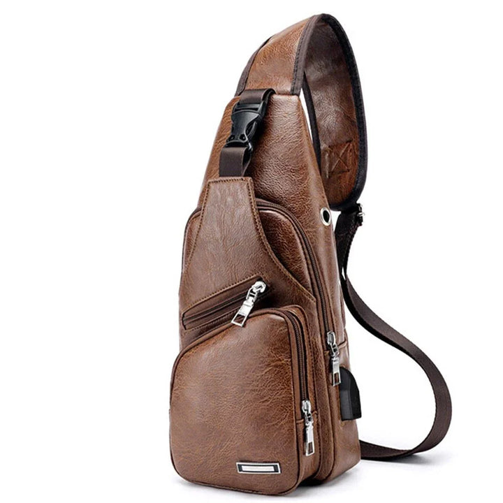 Brown leather sling crossbody bag with multiple zippered compartments and adjustable strap