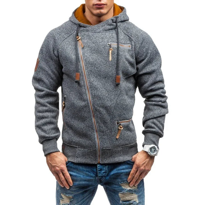 Man wearing stylish gray zip-up hoodie with brown accents and ripped blue jeans