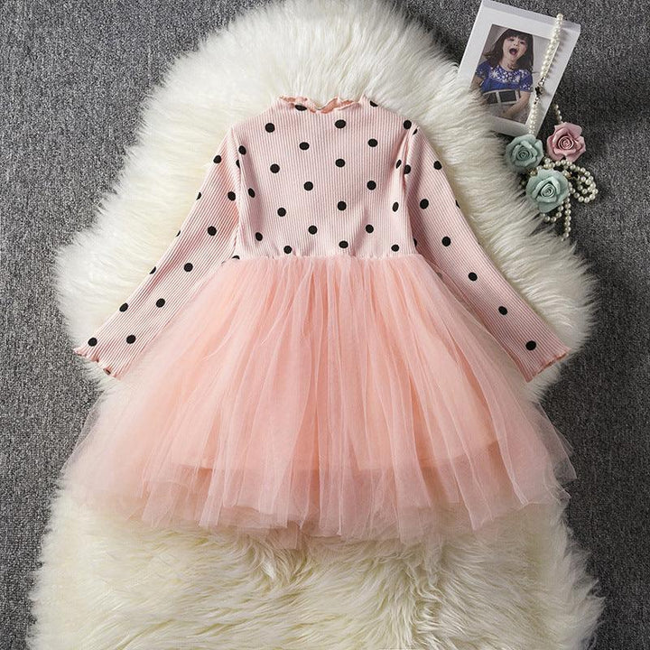 Pink polka dot long-sleeve top with layered tulle skirt for toddler girls on white fur rug