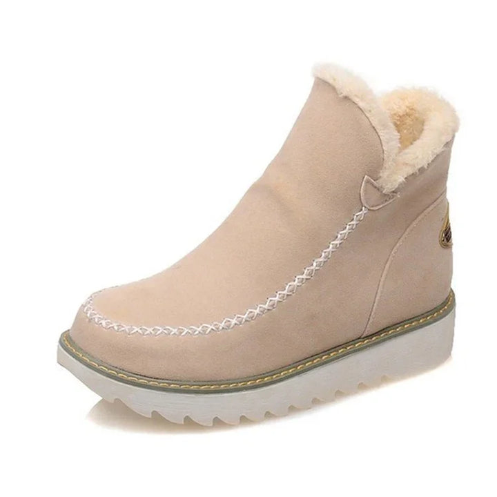 Beige suede winter boot with white stitching, fur lining, and thick rubber sole