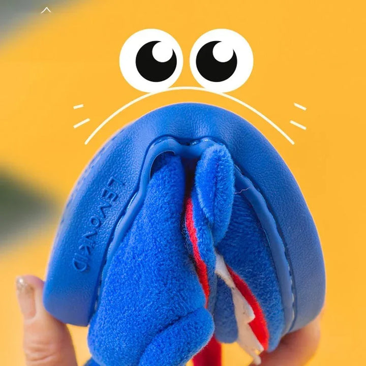 Close-up of blue soft dog toy with chew-resistant tag and cartoon eyes on yellow background