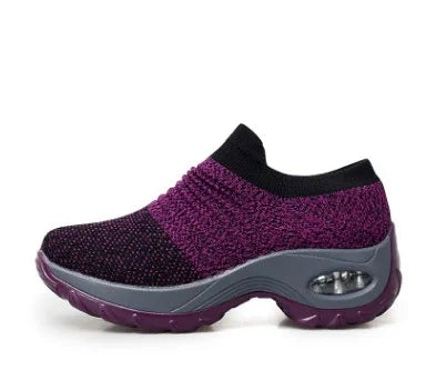 Purple and black slip-on knit athletic shoe with cushioned sole and air bubble heel