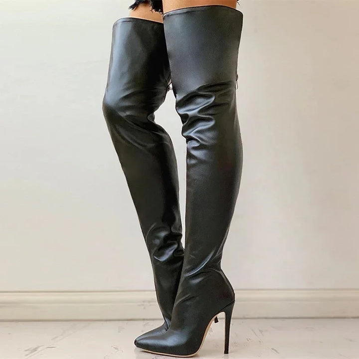 Black leather over-the-knee high heel boots with pointed toes on model