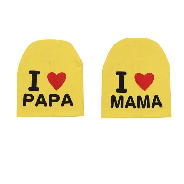 Pair of yellow baby hats with text I love Papa and I love Mama in black and red