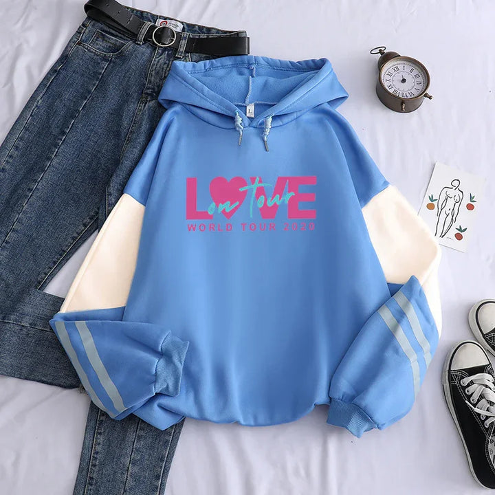 Blue hooded sweatshirt with love tour 2020 print paired with blue denim jeans and black belt