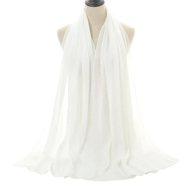 Elegant white chiffon scarf draped on a dress form against a white background