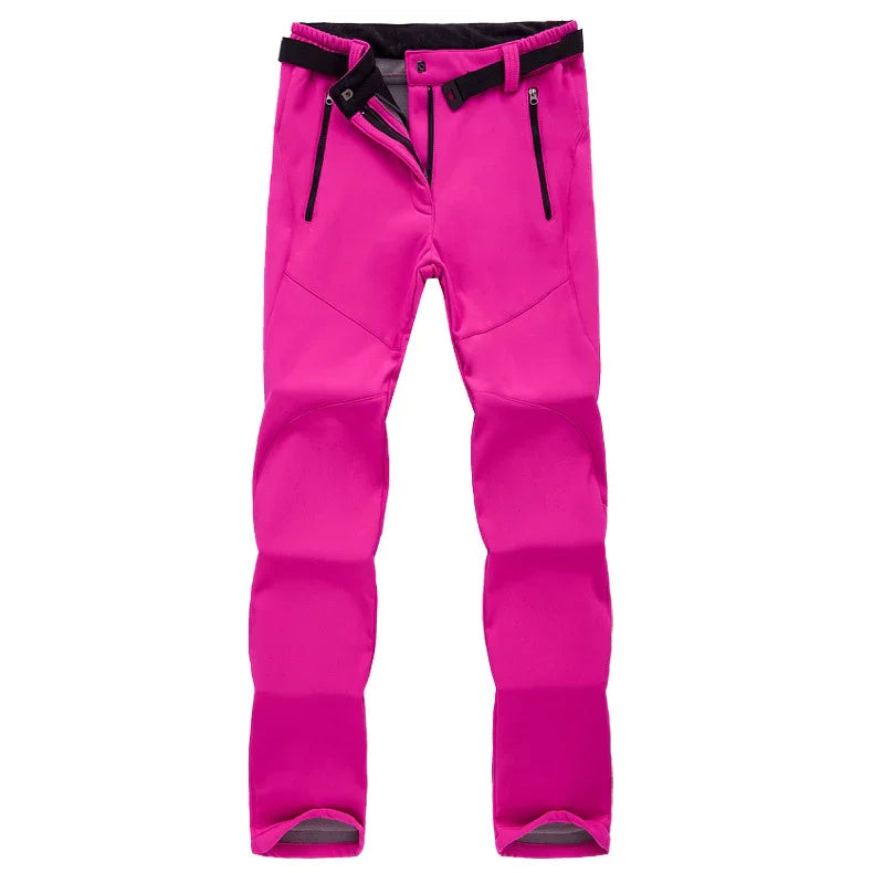 Bright pink softshell outdoor pants with black adjustable belt and zippered pockets