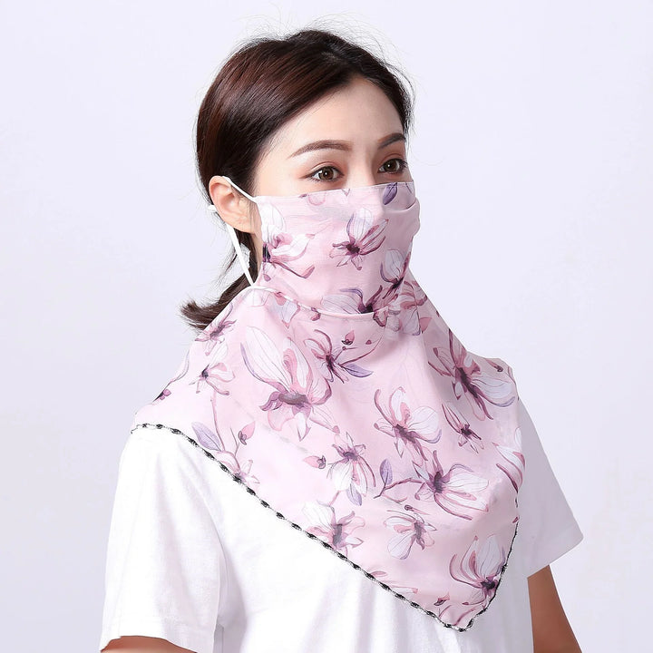 Woman wearing pink floral neck and face cover mask with white shirt on light background